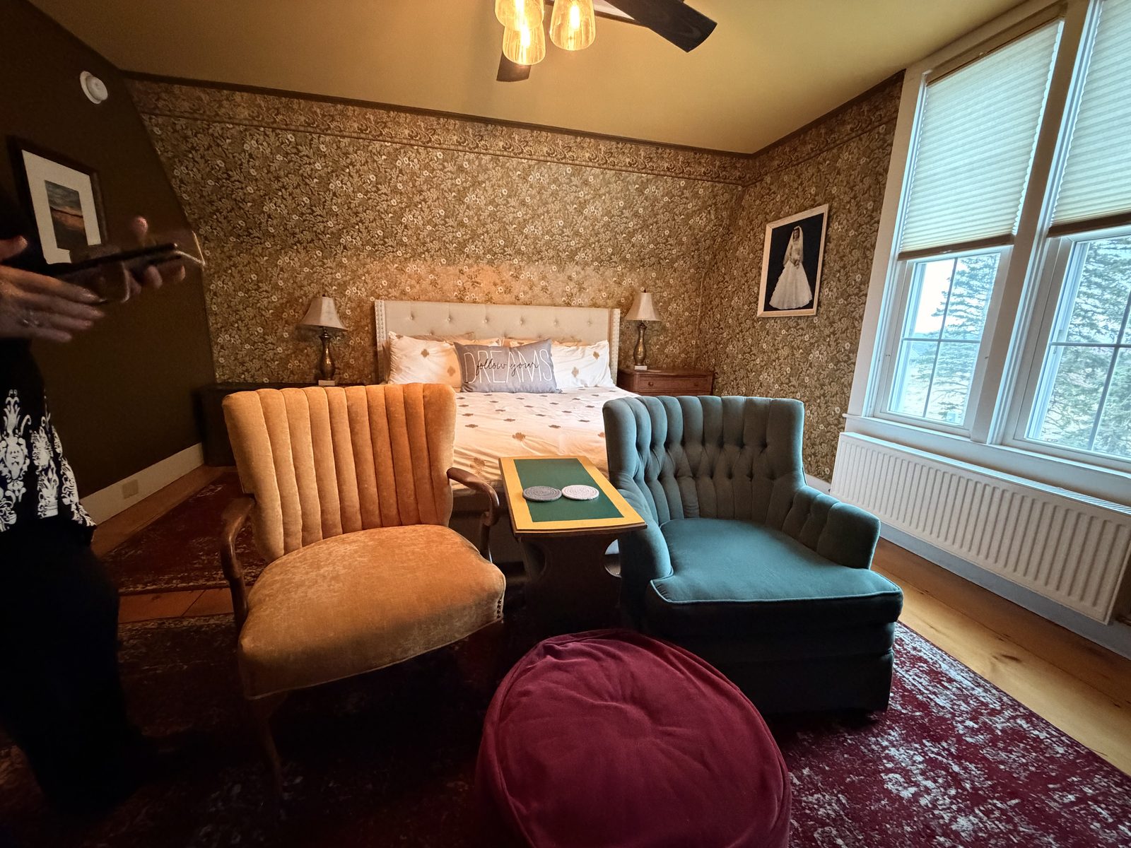 Happy Harvest Farmhouse Gold Room with floral wallpaper, Cal-king bed and vintage armchairs