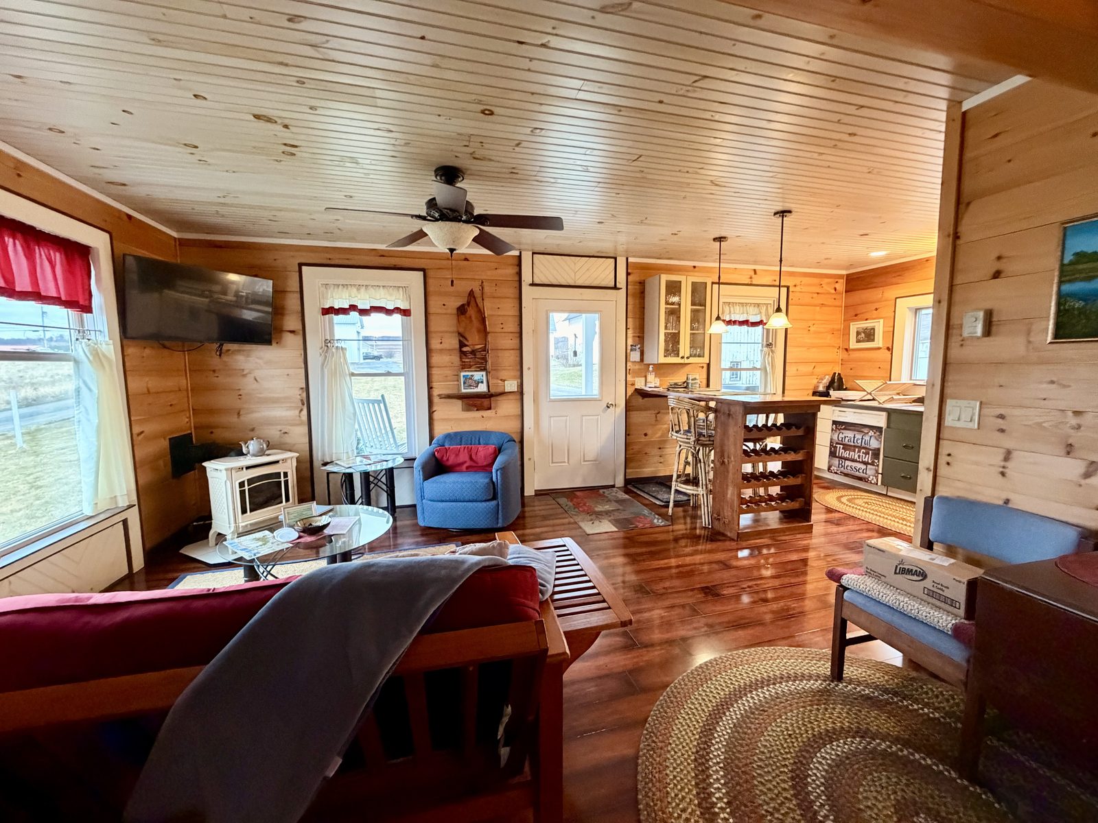 Fruit Packing House living space with pine walls, wood floors, kitchen bar and wine rack