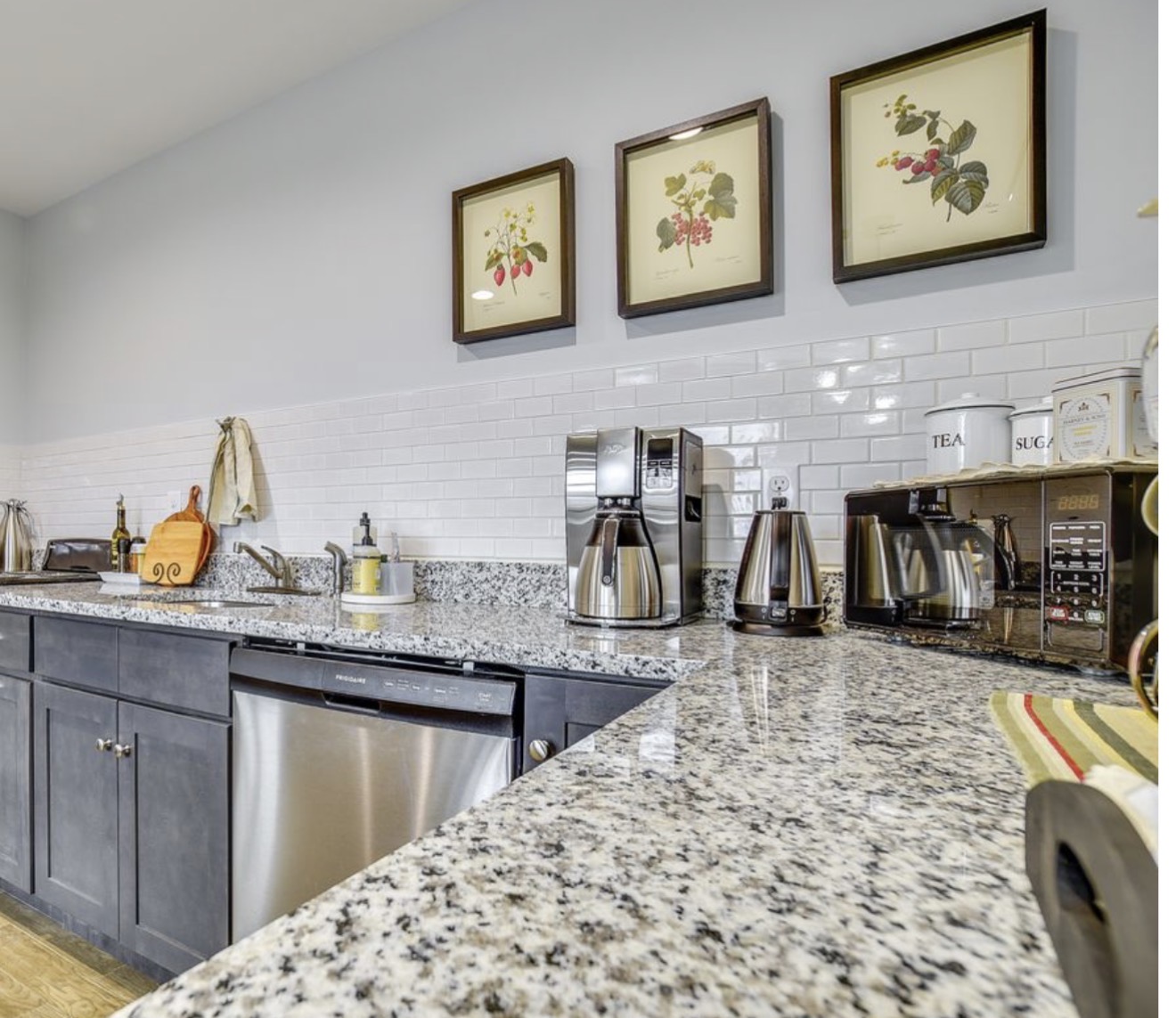 Second upstairs bedroom view with dresser, mirror, framed print and mini-split unit