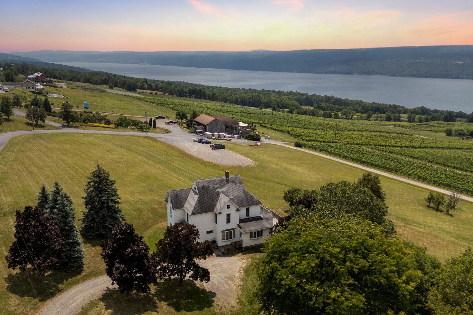 The Inn at Chateau LaFayette Reneau on its winery estate above Seneca Lake, with vineyards and the winery barn behind