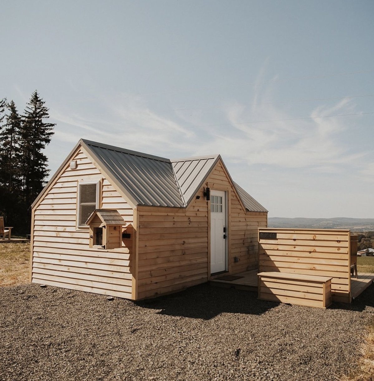 A FLX micro-cabin exterior with cedar siding and a private deck