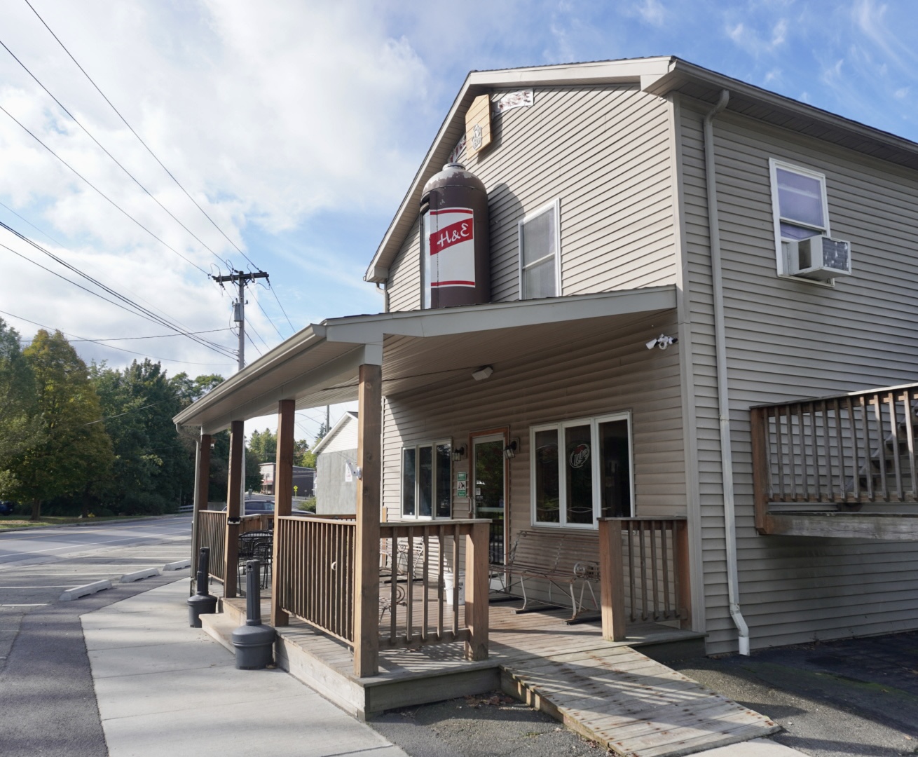 The H&E Bar exterior with iconic beer can sign