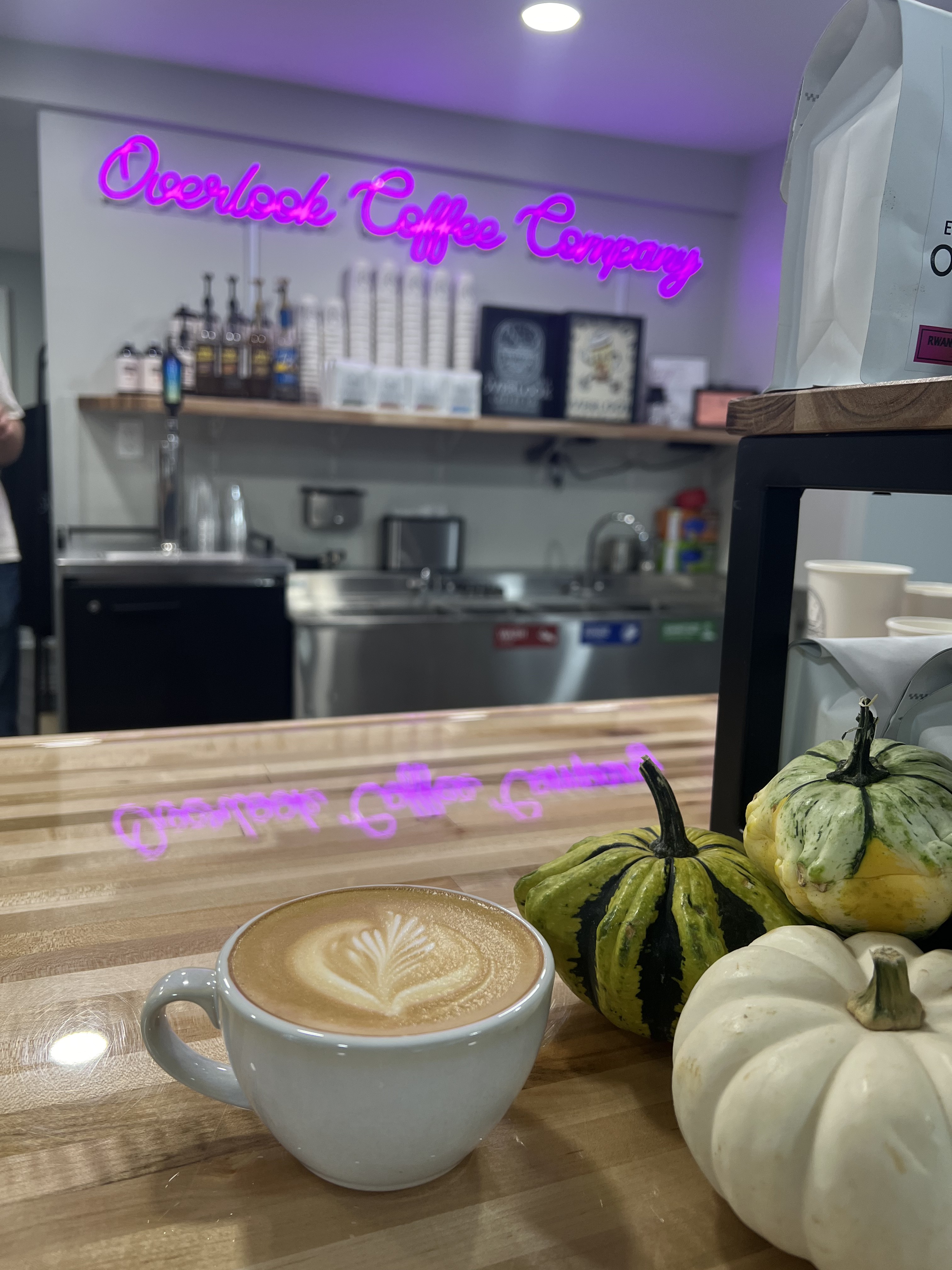 Overlook Coffee latte art with neon sign