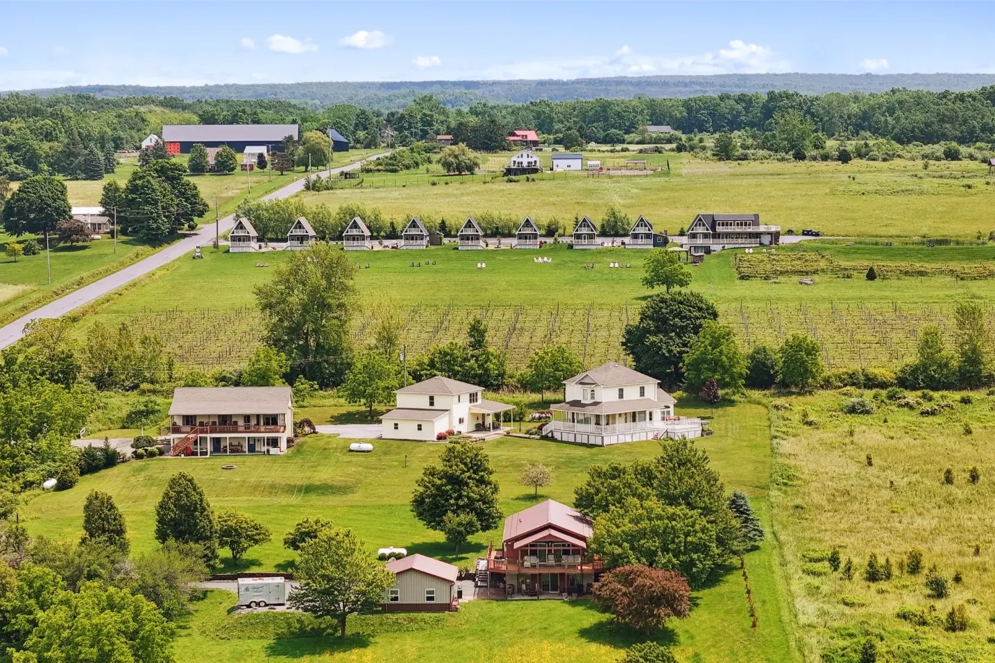 Aerial view of the Vineyard Villas A-frames lined along the ridge above Seneca Lake
