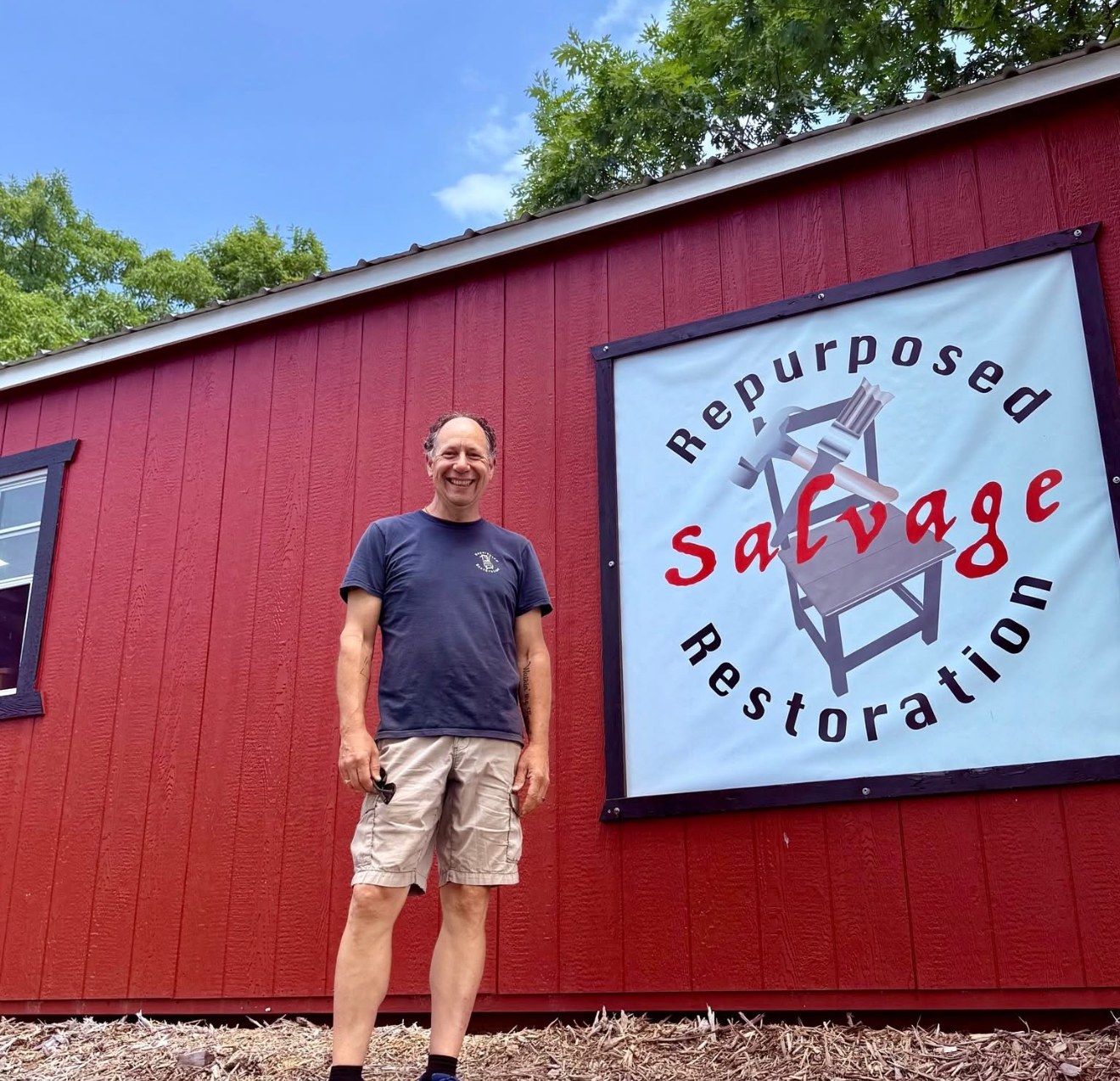 Salvage on Seneca storefront with Kevin and the Repurposed Salvage Restoration sign
